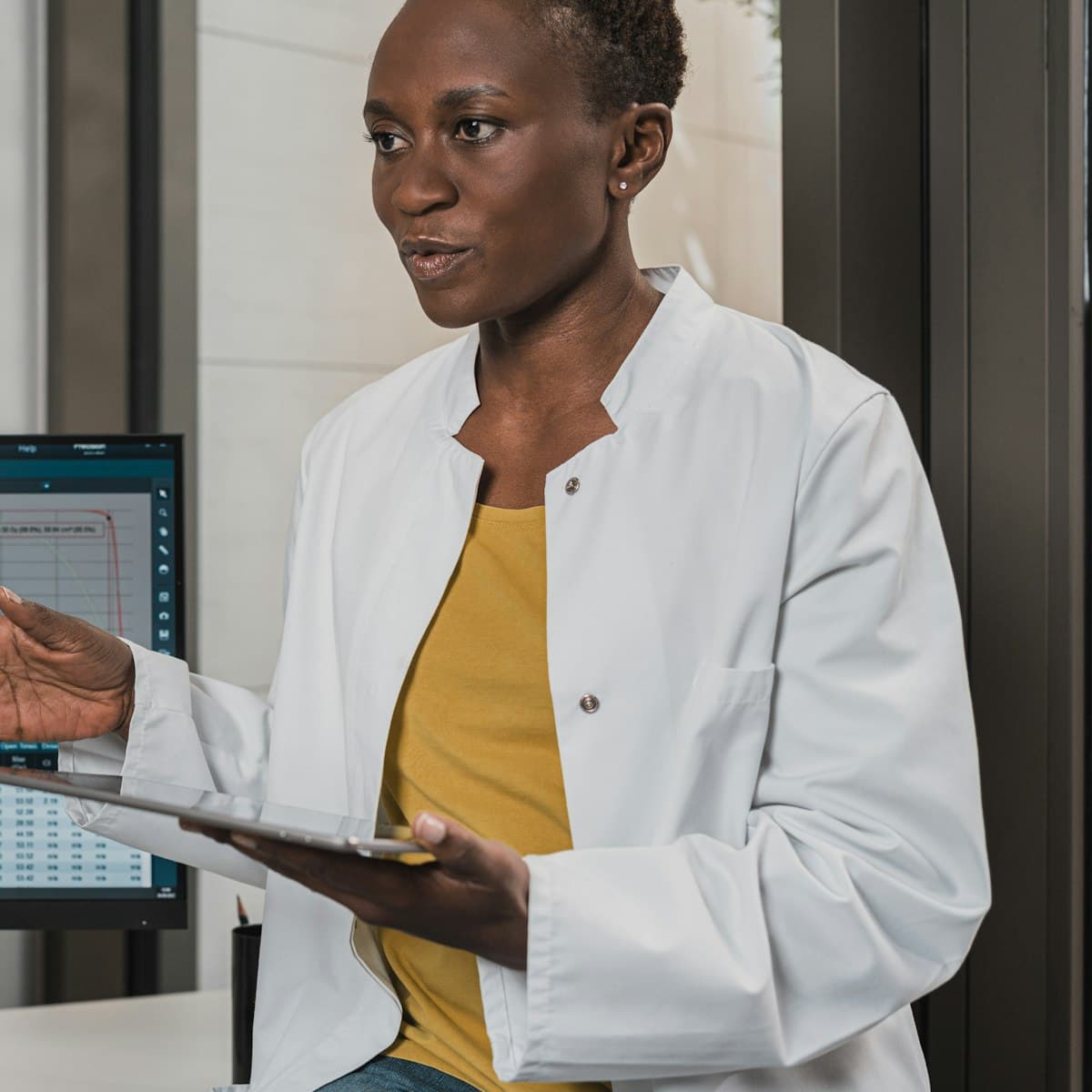A doctor sitting at eye level, talking a patient through their results